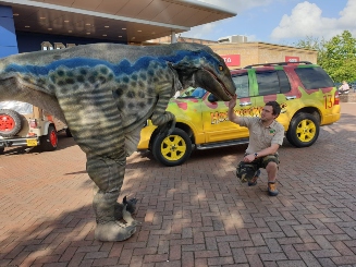 Dinosaur character and zookeeper at Hoo Zoo and Dinosaur World